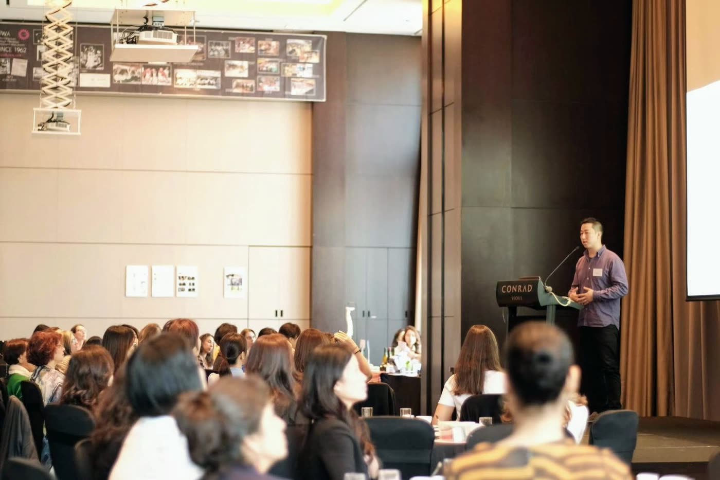 Audience seated at tables during a Create Wellness Center health seminar in Seoul