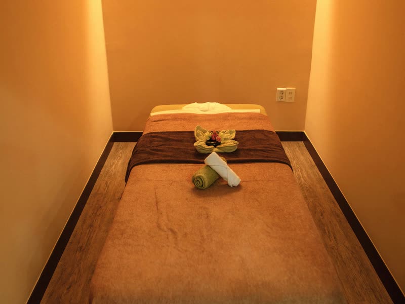 Massage treatment room at Create Wellness Center Itaewon with a made-up massage table and warm lighting