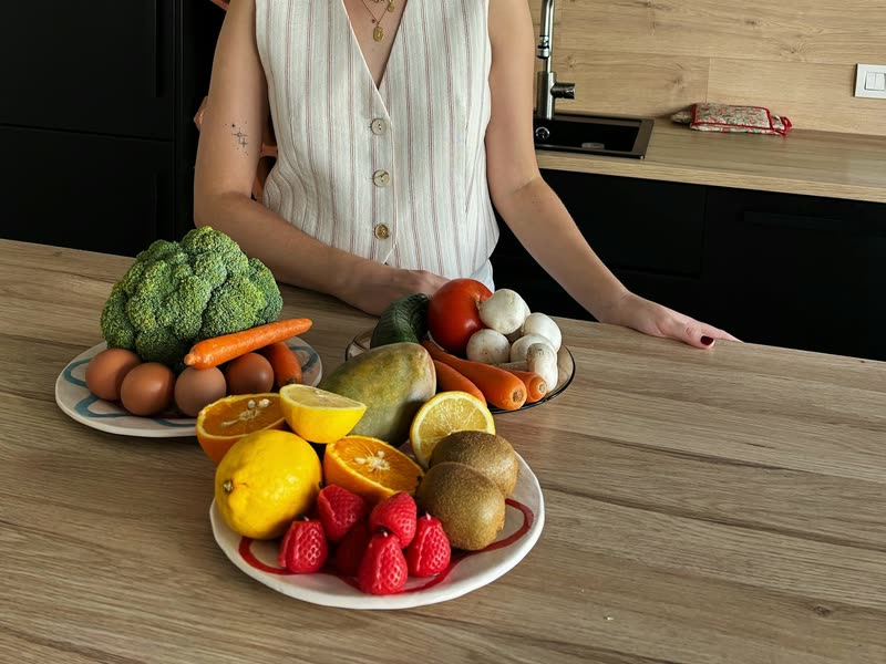 Fresh vegetables and fruit laid out on a kitchen counter during a nutrition consultation