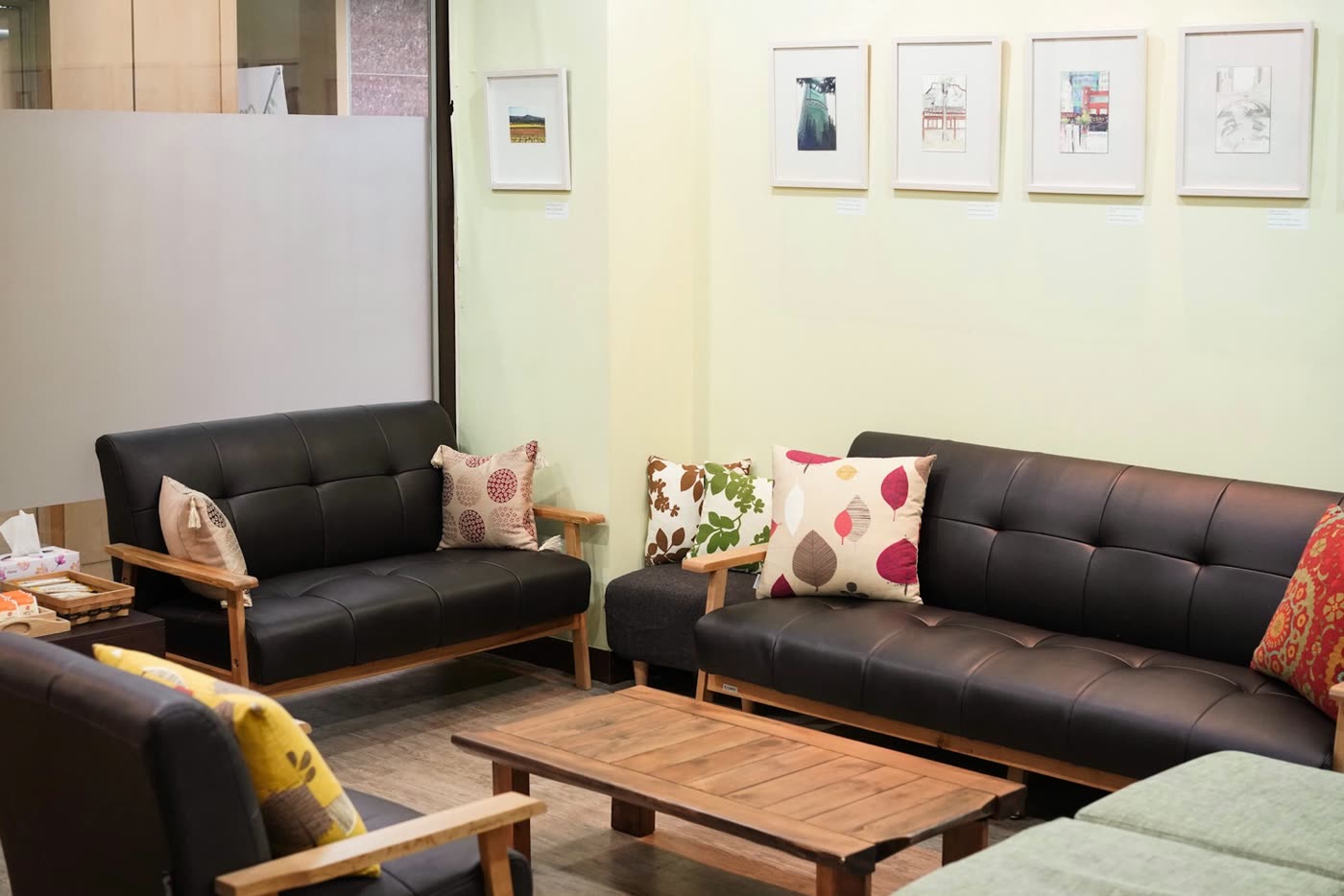The waiting area at Create Wellness Center Itaewon, with sofas beside the art wall